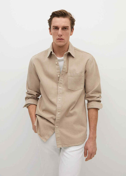 Beige men’s button-up shirt with long sleeves, button front, and chest pocket.
