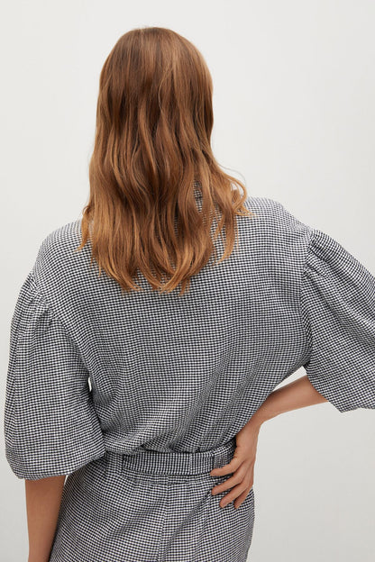 Black-and-white check short-sleeve belted playsuit, back view
