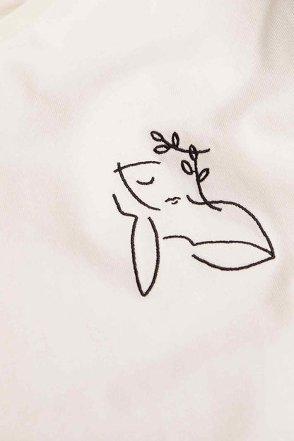 MANGO white T-shirt close-up of line-drawn figure graphic