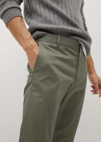 Khaki chino pants close-up: waistband with belt loops and curved side pocket.