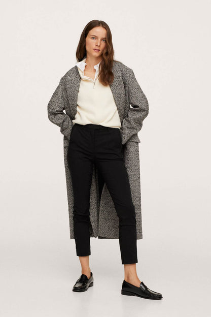 Black slim-fit ankle pants with tapered legs and cuffed hem