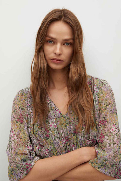 Green floral V-neck dress close-up, gathered bodice and sheer-style sleeves