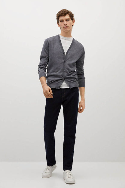 Grey knit cardigan with button front, V-neck; worn with dark jeans