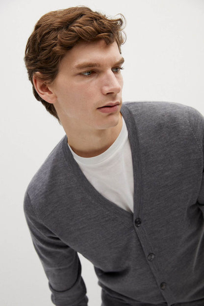 Close-up of grey knit cardigan V-neck and dark button placket