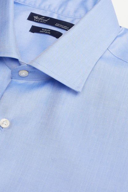 Sky blue button-up shirt collar close-up with white buttons and stitched placket