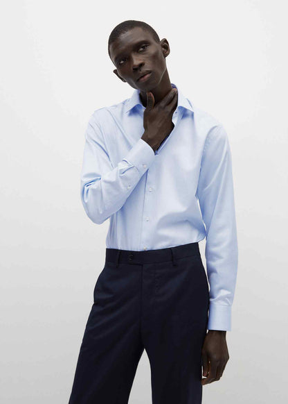 Light blue dress shirt with long sleeves, buttoned front and pointed collar