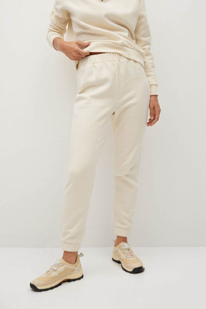 Ecru drawstring jogger pants with cuffed hems and side pockets