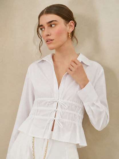 Licci white shirt-collar jumpsuit with button front and smocked peplum waist
