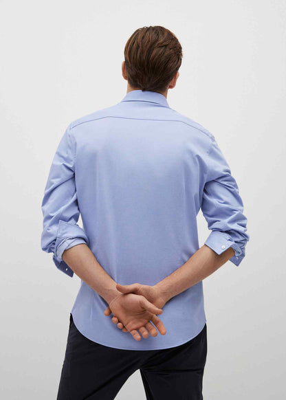 Men's sky-blue button-up shirt from back, long sleeves, collar visible