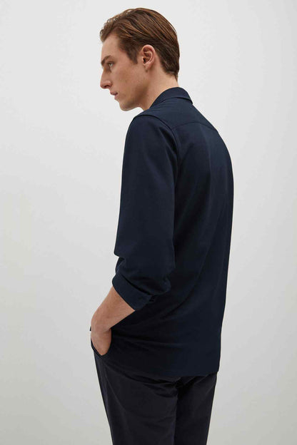 Navy button-up dress shirt in profile view, long sleeves
