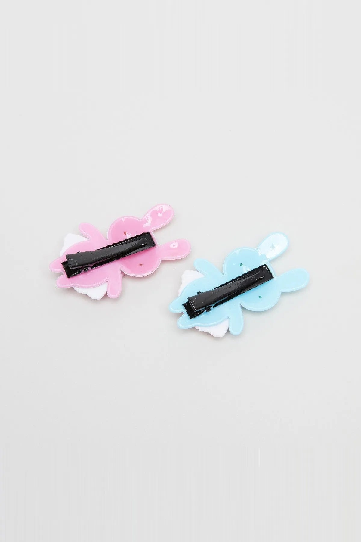 Rabbit hair clips with black snaps, pink and light blue plush bunny shapes