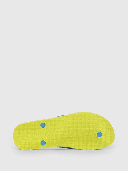 Yellow flip-flops with blue dots on the sole underside and tread detail