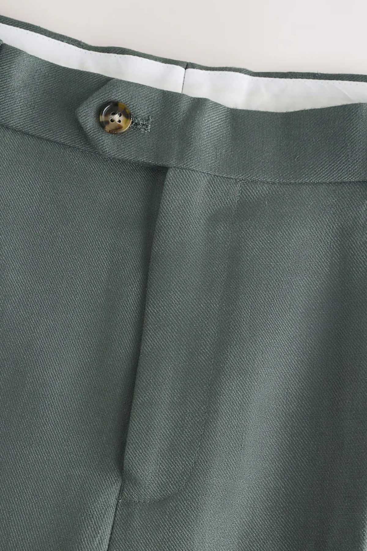 Green suit trouser waistband with button and fly facing