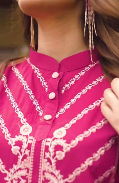 Close-up of shocking pink kurta neckline with gold embroidery and round buttons