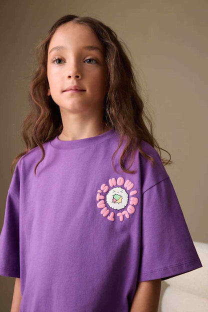 Kids purple graphic T-shirt with circular logo patch on front