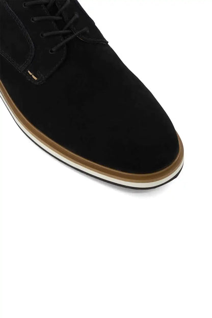 Black suede lace-up shoe upper with stitching detail and tan-trim sole