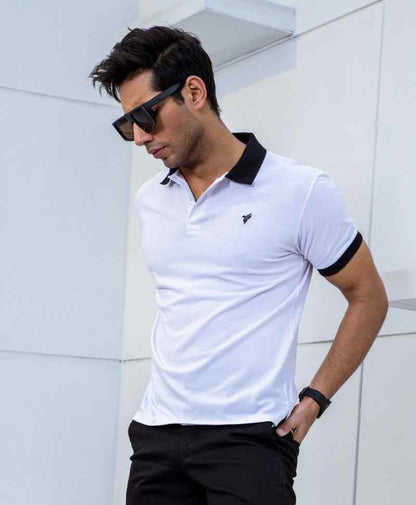 White fitted polo shirt with black collar and black sleeve cuffs, small chest logo
