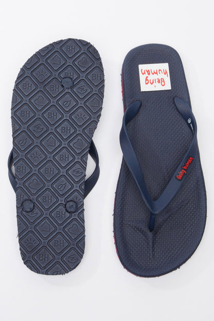 Navy flip-flops, one showing tread outsole; thong straps with red edge trim