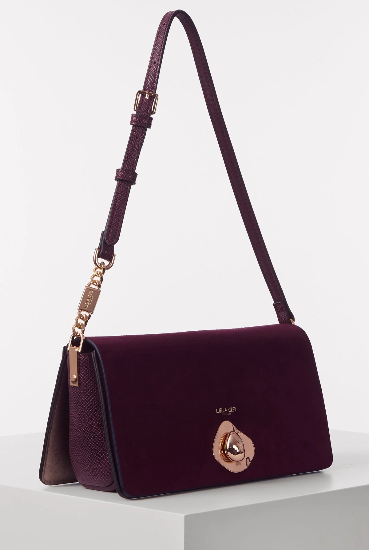 Purple crossbody shoulder bag with top flap and gold turn-lock clasp