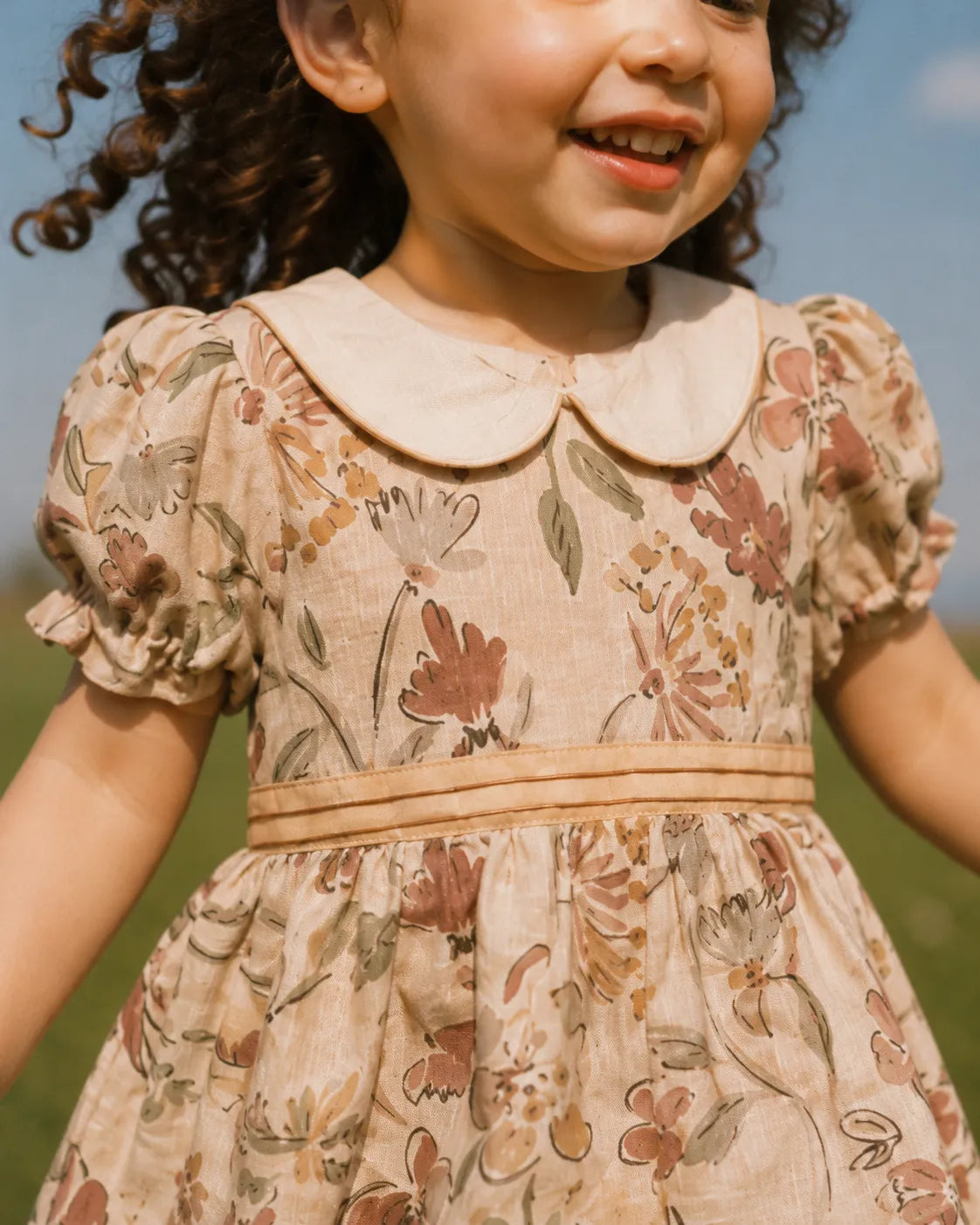 Licci beige floral baby dress with Peter Pan collar and short puff sleeves