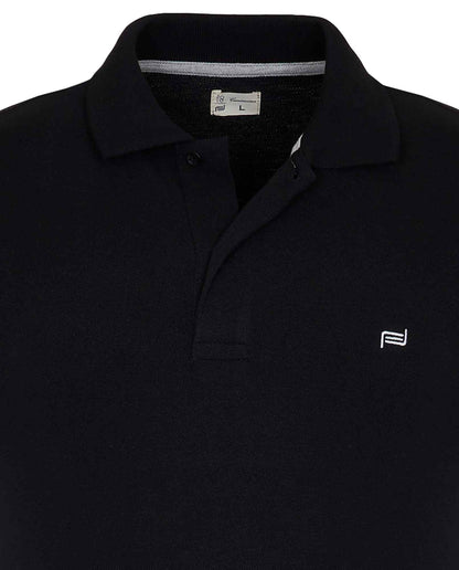 Black polo shirt close-up: flat collar, button placket, chest logo, neck label