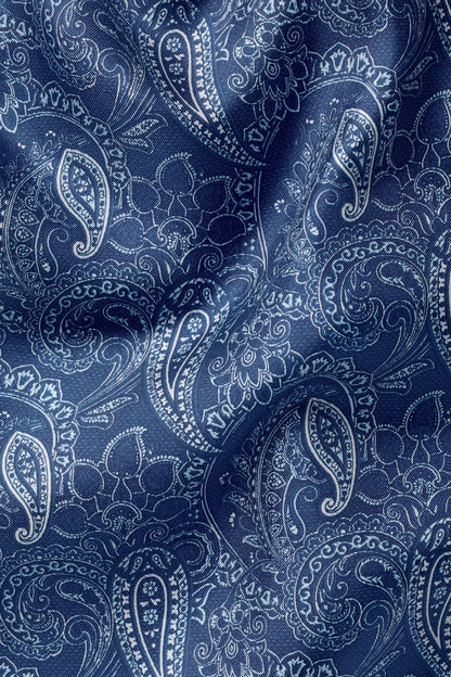 Blue paisley fabric close-up with paisley and floral motifs