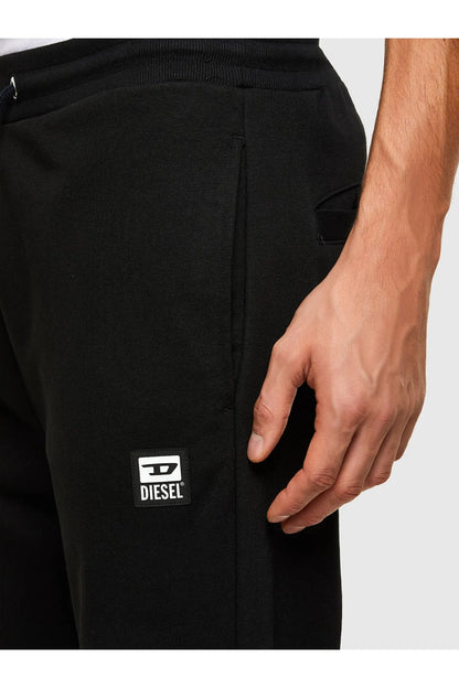Black jogger sweatpants with small Diesel logo patch at thigh