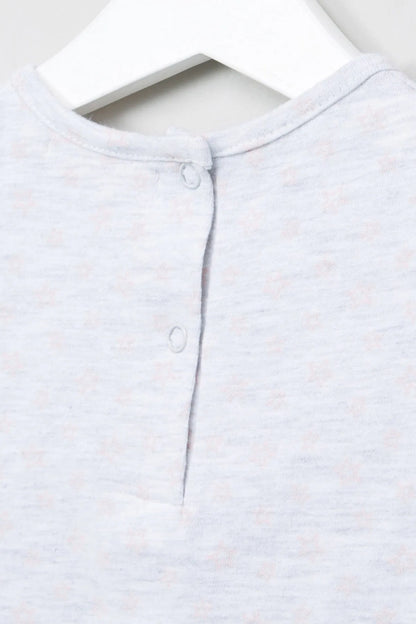 Lightweight baby top close-up: buttoned henley placket at crew neckline
