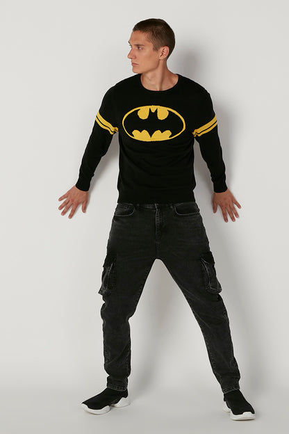 Black long-sleeve graphic sweatshirt with yellow bat logo and striped sleeve cuffs