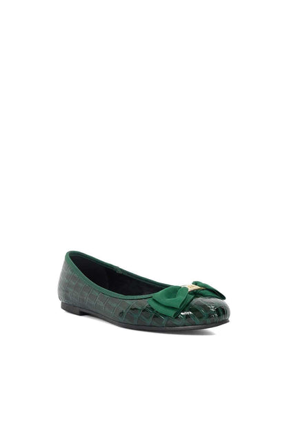 Green crocodile-embossed ballet flats with bow and low, flat sole.
