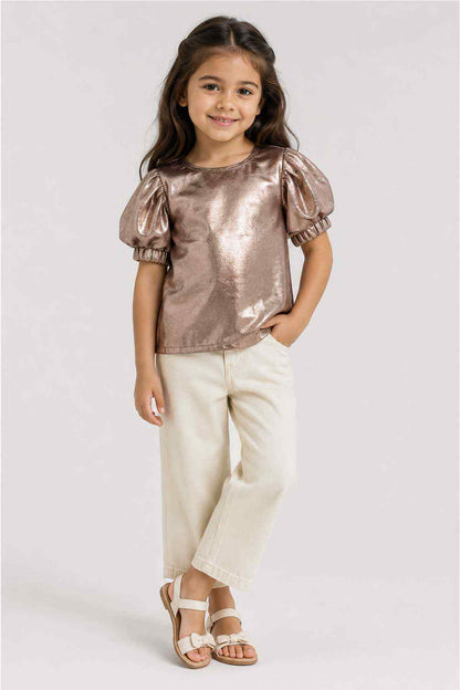 Metallic gold toddler top with puff sleeves and round neck, worn with cream pants