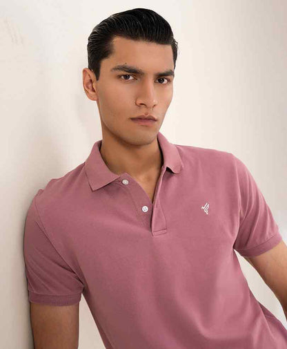 Fitted mauve polo shirt close-up, button placket and chest logo detail