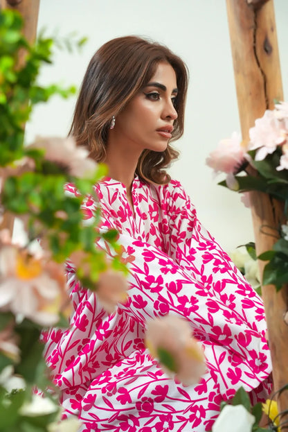 Close-up of pink and white leaf-print dress with round neckline and long sleeves