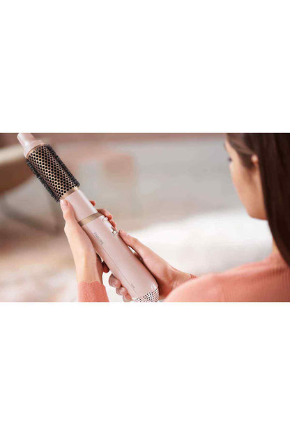 Philips hair styler brush in use, bristle barrel held near hair