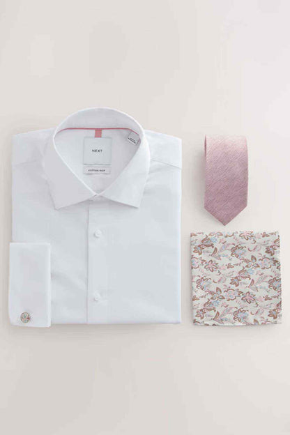 White dress shirt, pink tie, and floral pocket square on a flat lay