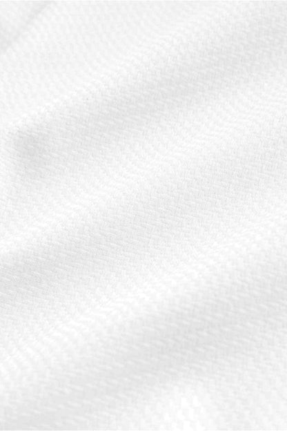 White dress shirt fabric close-up with subtle textured weave