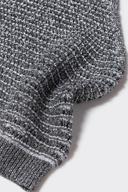 Speckled knit fabric close-up with ribbed hem and armhole trim