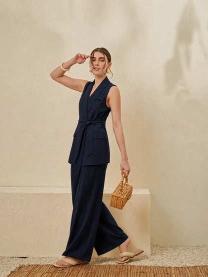 Navy sleeveless wrap jumpsuit with V-neck, belted waist, wide-leg pants