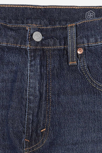 Blue denim jeans front with button-fly, rivets, and stitched seams