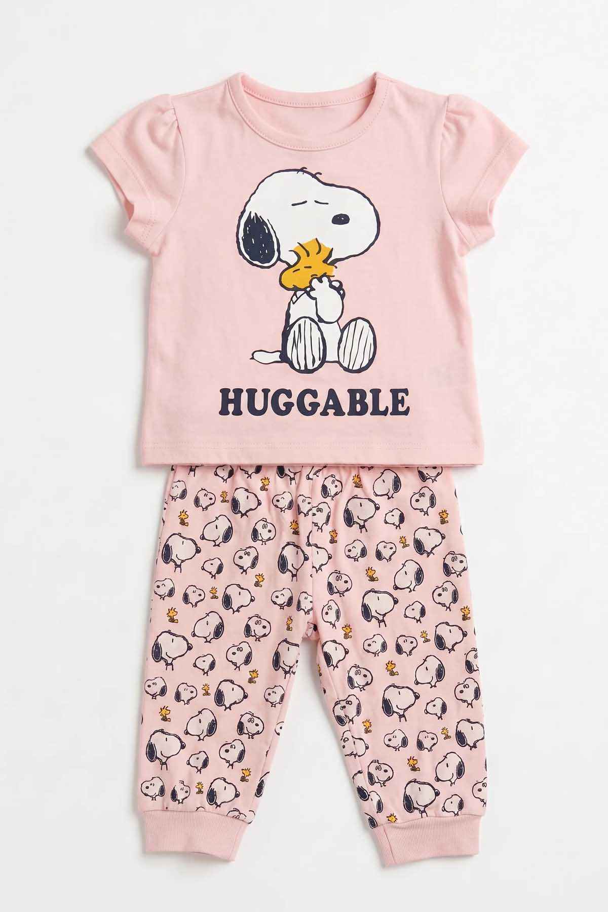 Pink baby pajama set with Snoopy-style graphic T-shirt and snoopy-pattern trousers