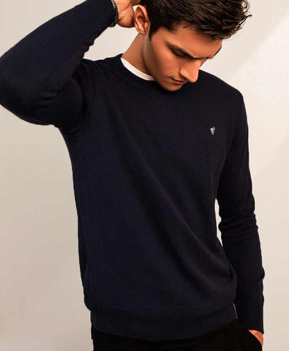 Navy fitted crewneck sweater with white rib collar and small chest logo detail