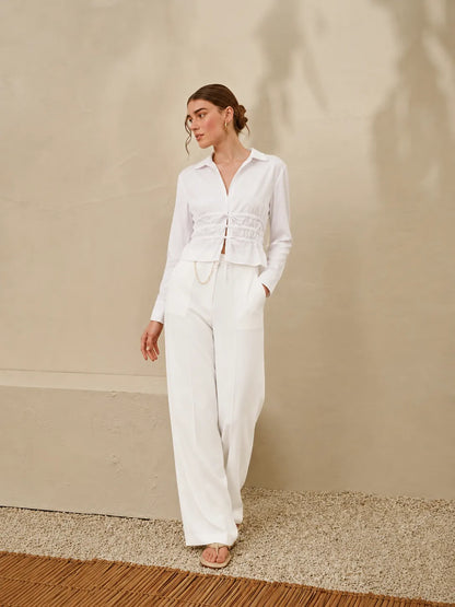 Licci white long-sleeve jumpsuit, button front, smocked peplum waist, wide-leg pants