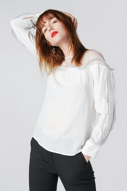 White sheer long-sleeve blouse with shoulder tie detail and ruffle trim