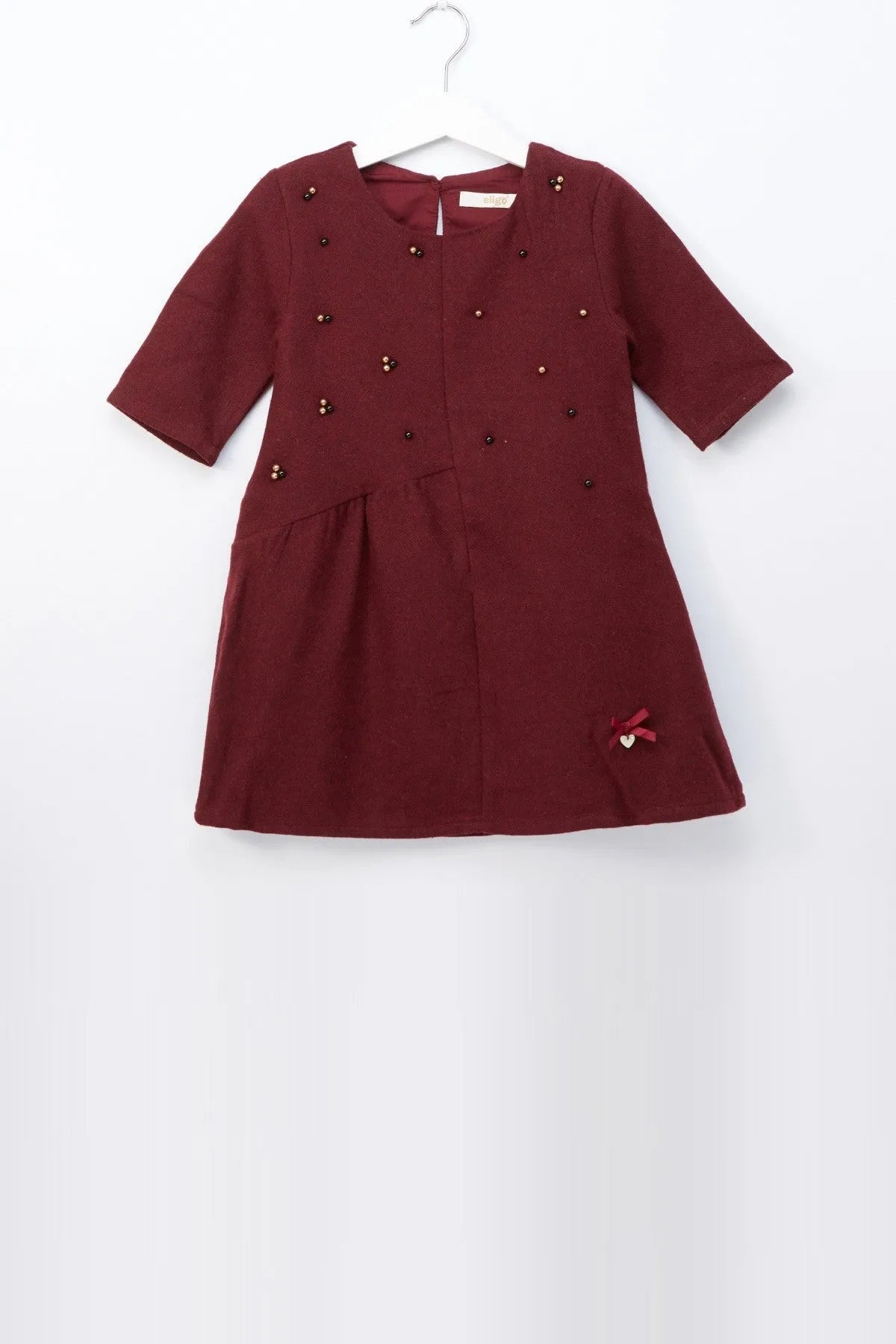 Burgundy baby dress with gold buttons, short sleeves, and small side bow detail