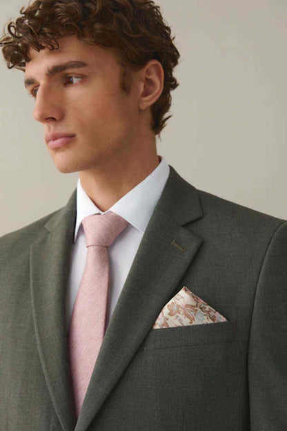 White dress shirt with pink tie, under dark blazer and floral pocket square
