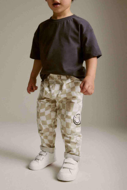 Kids checkered cargo pants with elastic waistband and smiley pocket, beige