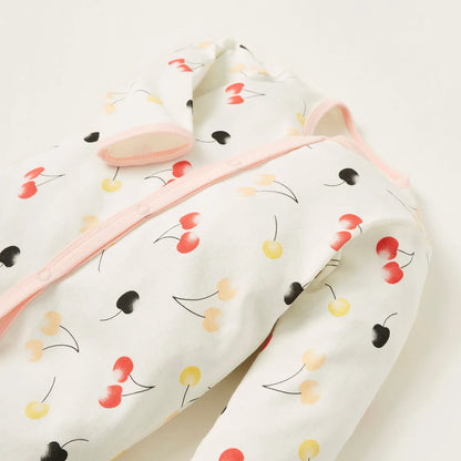 Multicolor fruit-print baby footie with pink-trim zipper and built-in cuffs