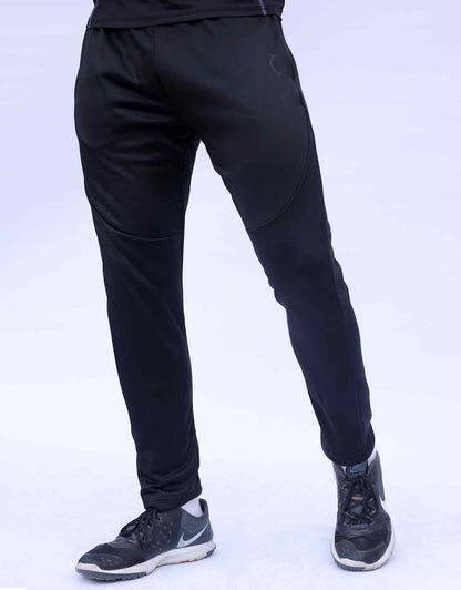 Black jogger pants on model, full leg view with stitched panel lines