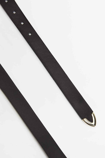 Black belt strap detail with metal eyelet holes and gold buckle tip
