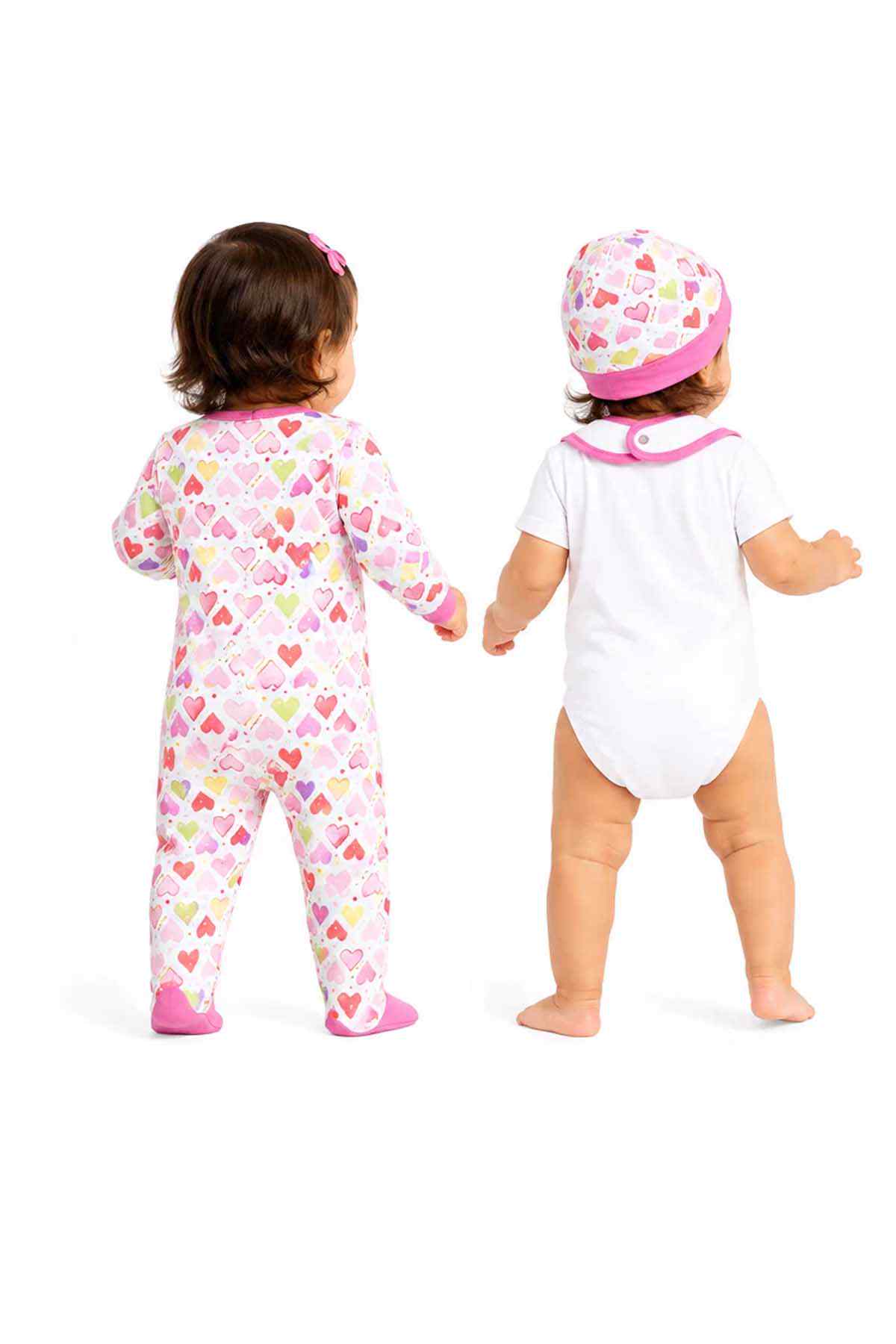 Back view: pink heart-print baby footed sleeper and white bodysuit with hat